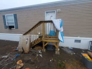 A messy yard with various debris and junk outside a mobile home, ready for cleanup by 701 Scrap in Williston, ND.