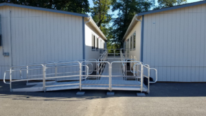 Metal access ramp and platform connecting two portable buildings, installed by Northwest Access Products LLC in Castle Rock, WA.