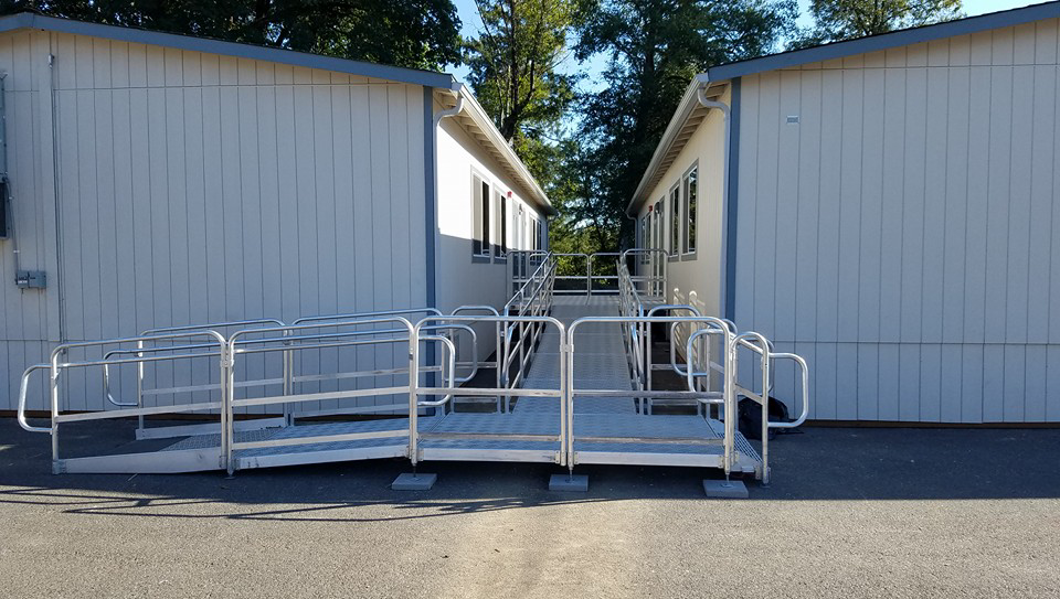 Metal access ramp and platform connecting two portable buildings, installed by Northwest Access Products LLC in Castle Rock, WA.