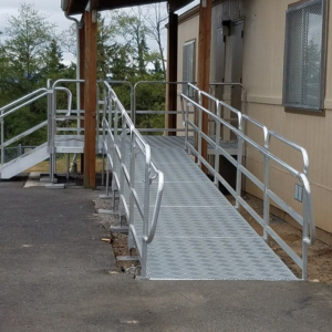 Newly installed metal access ramp and stairs leading to a portable building by Northwest Access Products LLC in Castle Rock, WA.