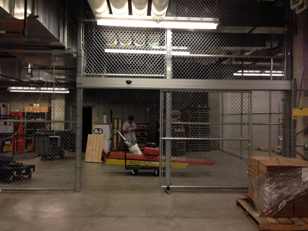 Workers installing a new metal canopy or roof structure by Security Fence & Construction Inc in Minneapolis, MN.