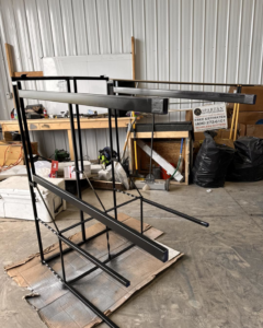 A metal frame being fabricated or repaired in a workshop by Devil Dog Services LLC in Billings, MT.