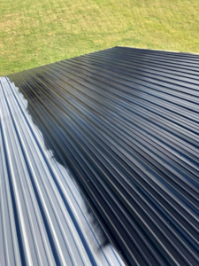 Before and after view of metal roof cleaning and painting by Extreme Precision Painting in Elizabethtown, KY.