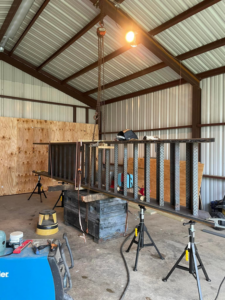 A large metal structure being fabricated in a workshop, part of a general contractor project by SJ Construction Services LLC in Austin, TX.