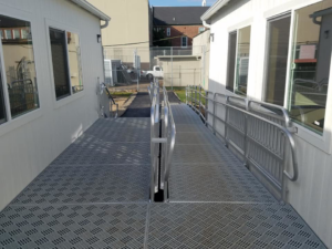 Textured metal walkway connecting two portable buildings, a project by Northwest Access Products LLC in Castle Rock, WA.