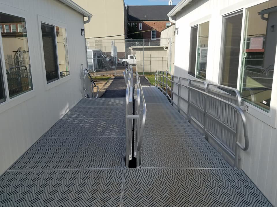 Textured metal walkway connecting two portable buildings, a project by Northwest Access Products LLC in Castle Rock, WA.