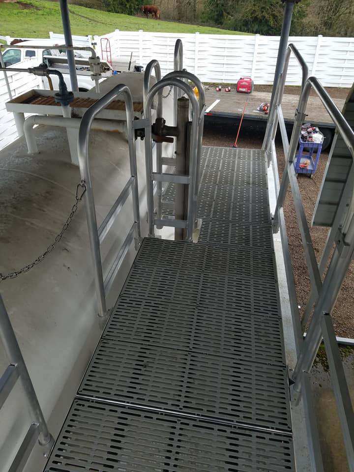 Custom metal walkway and handrails installed on an industrial tank by Northwest Access Products LLC in Castle Rock, WA.