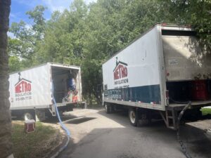Metro Insulation trucks and equipment set up at a job site, ready for an insulation project in Rockford, IL.