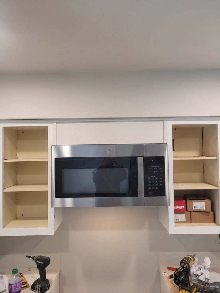 A newly installed over-the-range microwave in a kitchen by Precision Craftsman LLC in San Antonio, TX.
