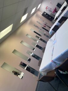 Multiple decorative mirrors professionally mounted on a wall in a commercial space by IFixdIt Handyman Services in Omaha, NE.