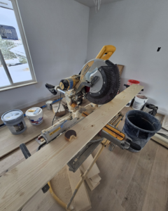 A miter saw set up for wood cutting and trim installation by Do It Right Or Do It Twice, LLC in Denver, CO.