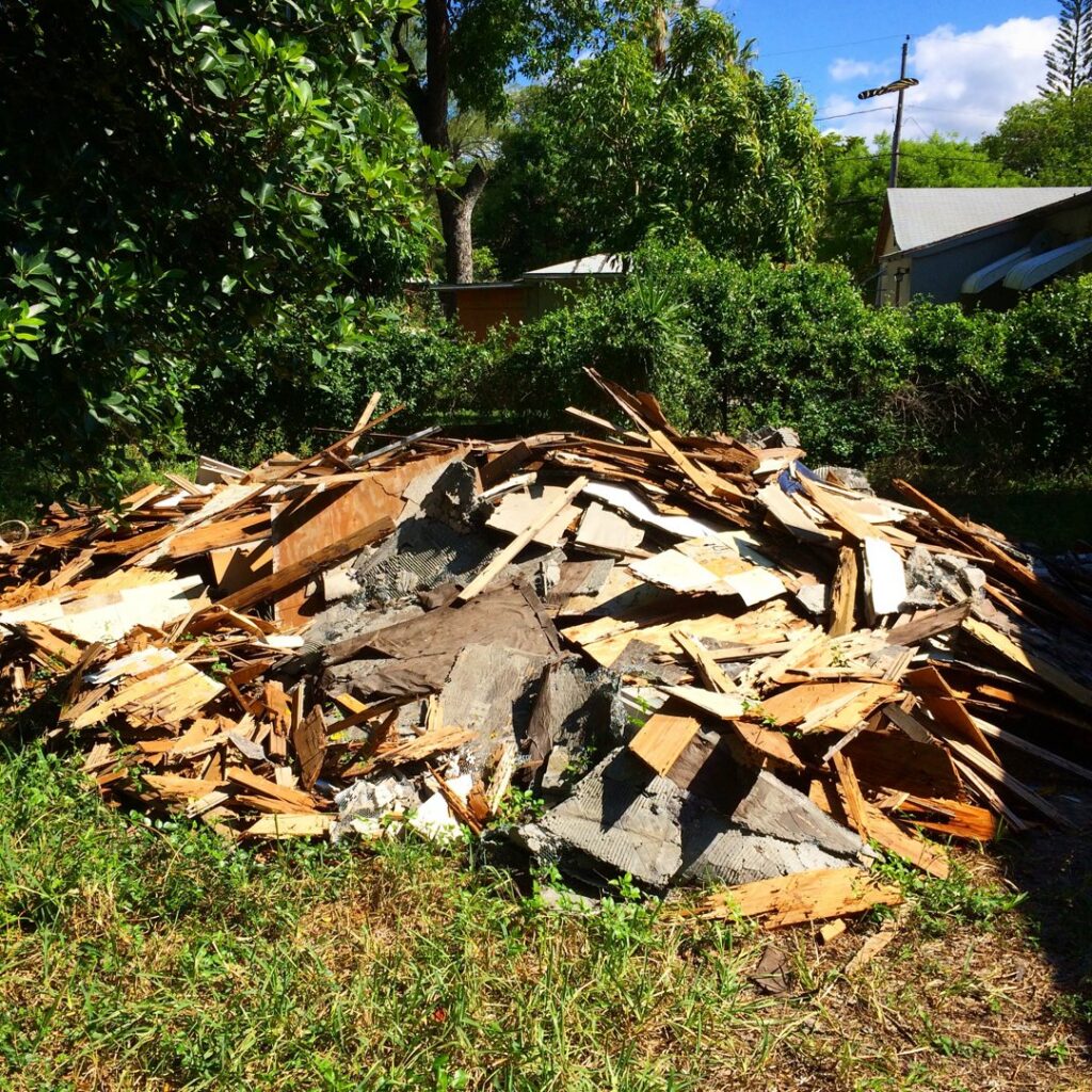 A large pile of mixed construction and demolition debris ready for pickup by Gator Junk Removal in Miami, FL.