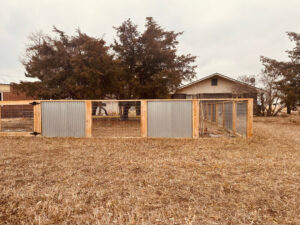 A mixed-material fence with wood, wire mesh, and corrugated metal by GreenView Solutions in Denver, CO.