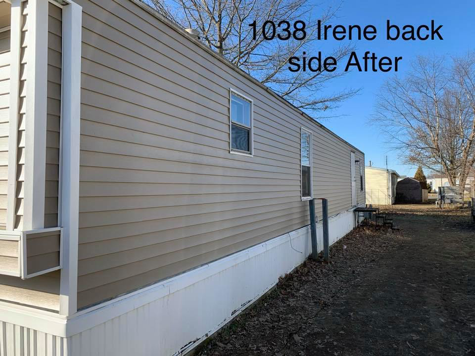 After photo showing the back side of a mobile home with new tan siding installed by Smith Construction Managment in Fort Wayne, IN.