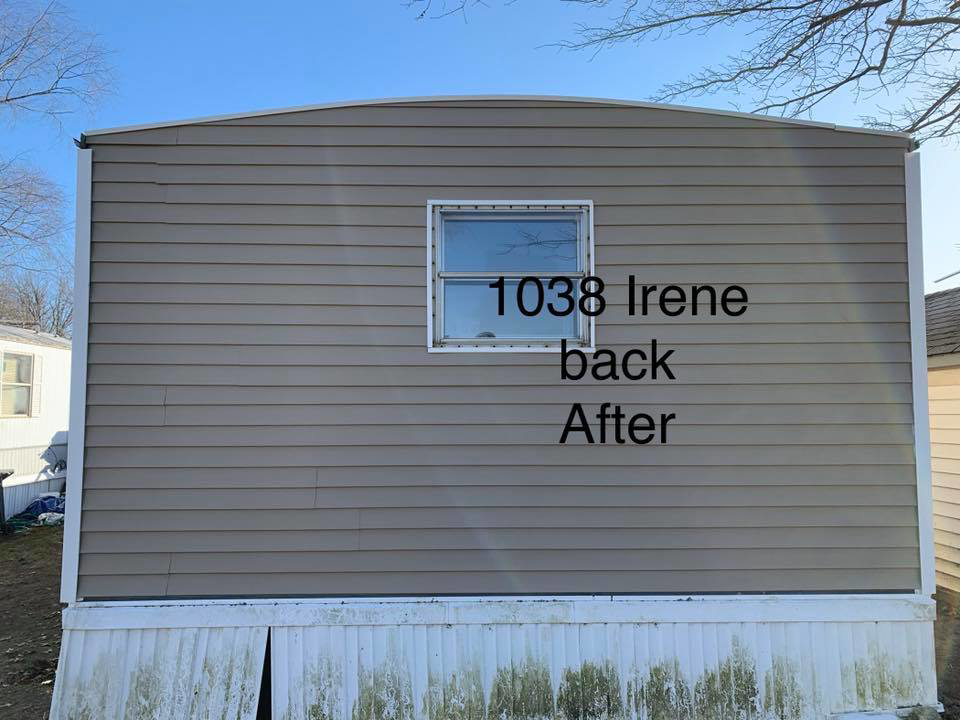 After photo showing the back end of a mobile home with new tan siding installed by Smith Construction Managment in Fort Wayne, IN.
