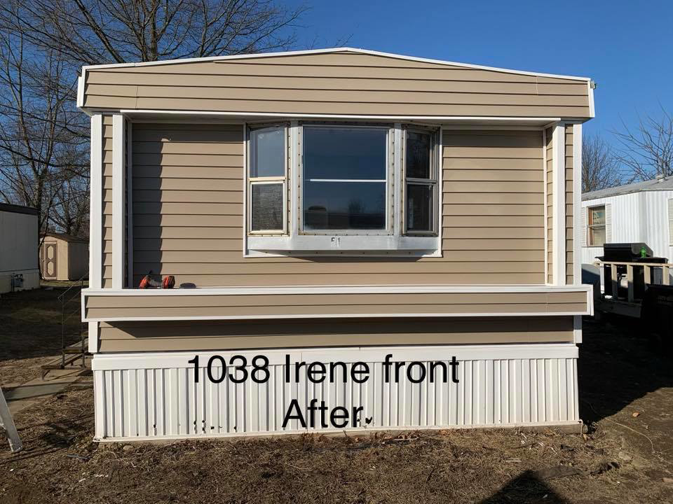 After photo showing the front side of a mobile home with new tan siding and trim installed by Smith Construction Managment in Fort Wayne, IN.