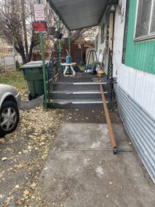 Repair or installation of mobile home steps and railing, with tools on the steps, by No Delay SVCS in Pocatello, ID.