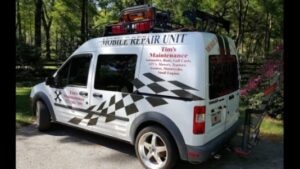 A white mobile repair unit van with Tim's Maintenance & Repair branding and checkered flag design in Las Vegas, NV