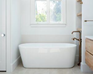 A modern bathroom featuring a freestanding tub and brass floor-mounted faucet, installed by Home Made Easy in Norwalk, CT.