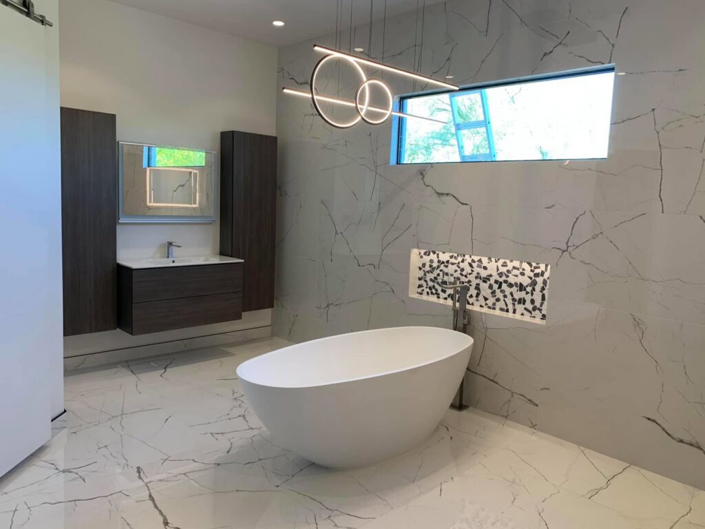 A modern bathroom with a newly installed freestanding tub and floating vanity by Dahlman Construction in San Tan Valley, AZ.