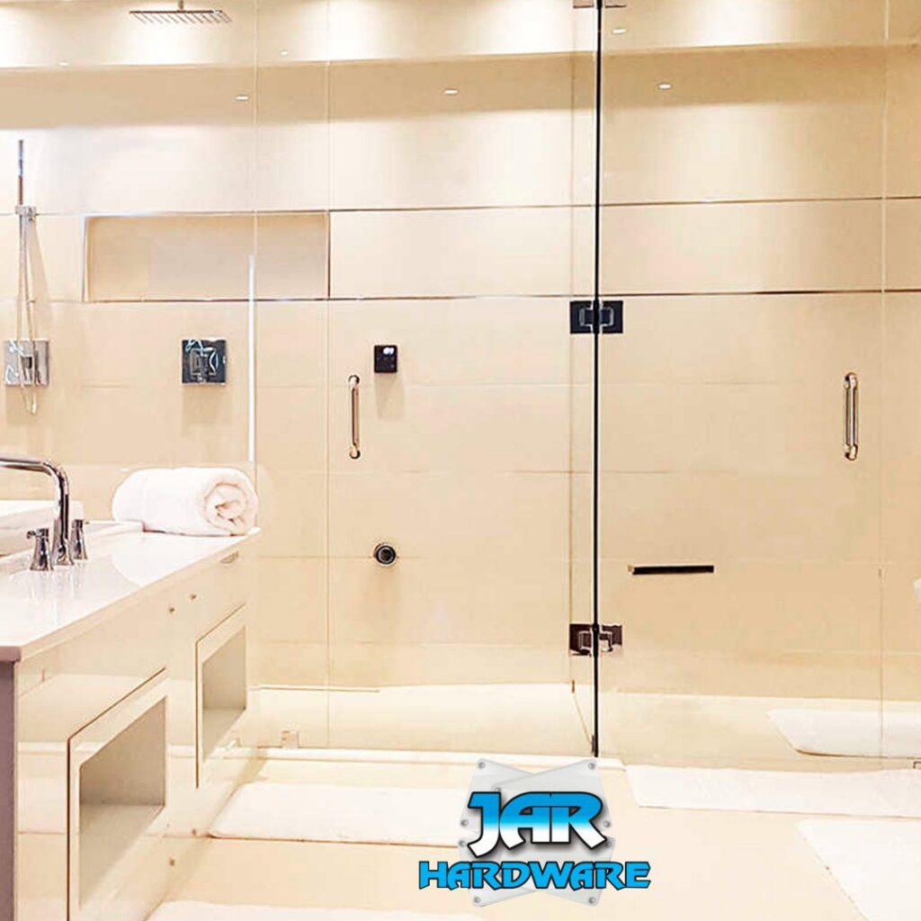 A modern bathroom with a clean glass shower enclosure and light-colored tiles installed by Jar Hardware in Hialeah, FL.