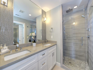 A modern bathroom remodel featuring a double vanity and glass shower by Nelson Tile and Stone in Bend, OR.