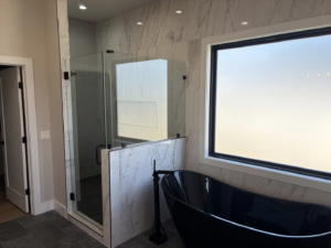 A modern bathroom remodel featuring a glass shower and freestanding tub by ELS Construction in Springfield, MO.