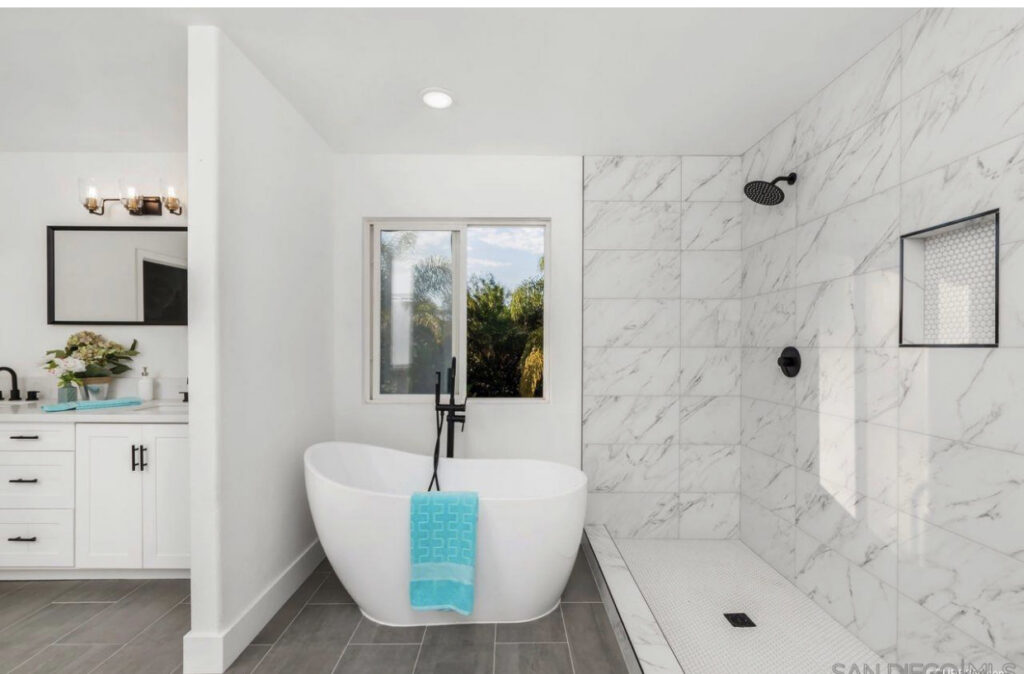 A modern bathroom remodel featuring a freestanding tub and a tiled walk-in shower by FD Handyman in San Diego, CA