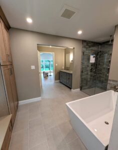 Modern bathroom remodel featuring a freestanding tub and glass shower by Roche Painting in Allentown, PA.