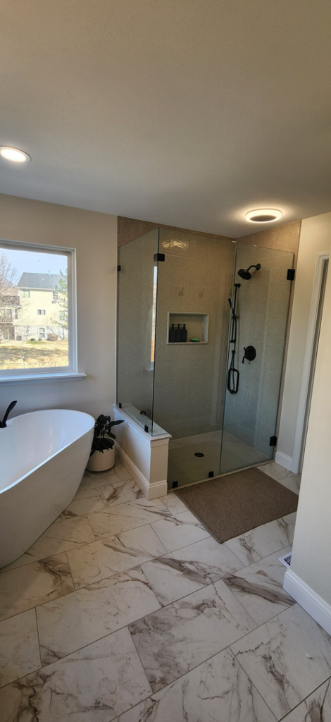 A modern bathroom remodel featuring a freestanding tub and walk-in shower by Willhite Construction in O'Fallon, MO.