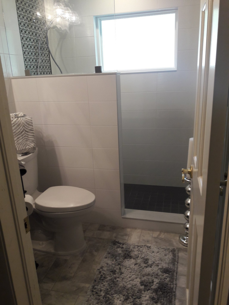 A beautifully completed modern bathroom remodel with new tiling by Guaranteed Installations in Tampa, FL.