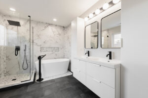 A luxurious modern bathroom remodel with a freestanding tub and glass shower by Inland Home Remodeling Inc. in Chicago, IL.