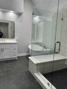 A modern bathroom remodel featuring a freestanding tub and glass shower enclosure by Master Building & Remodeling, Inc. in Concord, NC