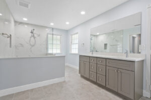 A spacious and modern bathroom remodel featuring a walk-in shower and a double vanity, completed by Stormtroopers Home Improvement in Port St. Lucie, FL.