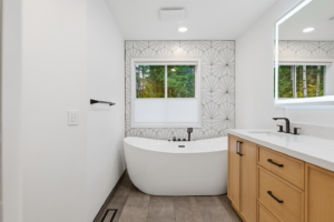 A complete modern bathroom remodel featuring a freestanding tub and vanity by BelRed Construction in Bellevue, WA.