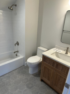 A modern bathroom remodel showcasing a new vanity, sink, and mirror by Harris Home Creations in Philadelphia, PA.