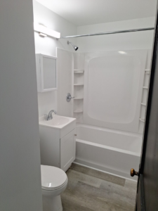 A modern bathroom renovation featuring a new vanity, toilet, and shower by Achieve Renovations in Pittsburgh, PA.