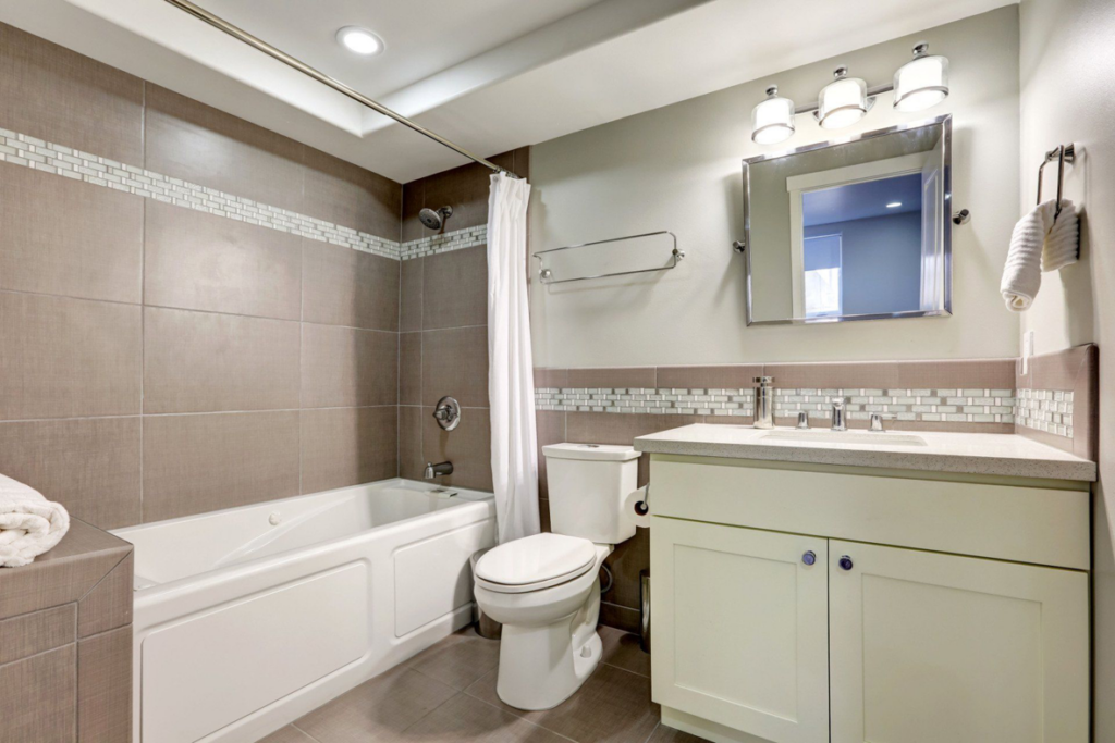 A modern bathroom renovation featuring a new bathtub, toilet, and vanity completed by Bath Pro in Florence, KY