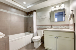 A modern bathroom renovation featuring a new bathtub, toilet, and vanity completed by Bath Pro in Florence, KY