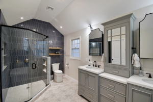 A modern bathroom renovation featuring a glass shower, toilet, and double vanity by Build Simple in Sterling, MA.