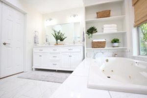 A bright modern bathroom renovation with a double vanity and built-in shelves by Andalex Construction LLC in Gresham, OR.