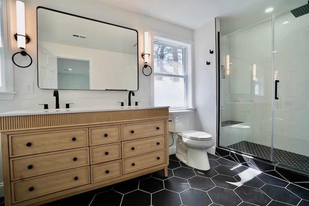 A modern bathroom renovation featuring a double vanity and walk-in shower by Orival Property Services in Boston, MA.