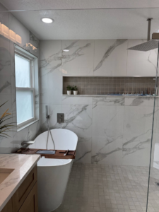 A modern bathroom renovation featuring a freestanding tub and tiled walk-in shower by Amazing Spaces 21 in Orlando, FL