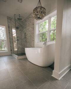 A modern bathroom renovation featuring a freestanding tub and glass shower by Heroic Builders LLC in Greenville, SC.