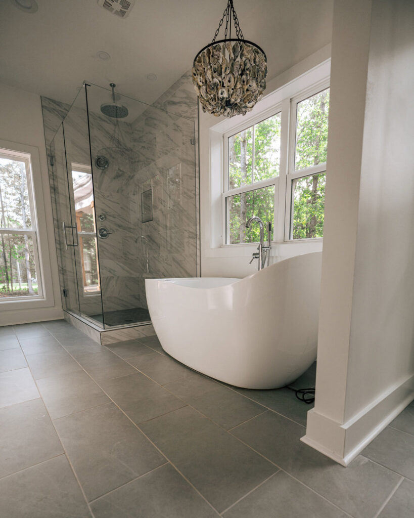 A modern bathroom renovation featuring a freestanding tub and glass shower by Heroic Builders LLC in Greenville, SC.