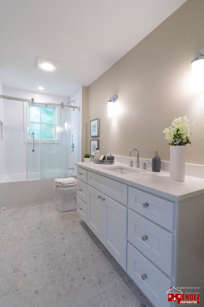 A modern bathroom renovation featuring a double vanity and glass shower completed by Mendez Contractor Inc in Lynn, MA