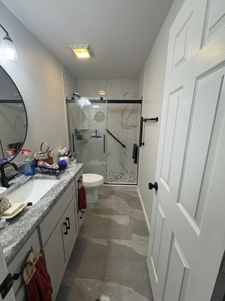A modern renovated bathroom with a walk-in shower and new vanity by Savage Home Builders in Hodgenville, KY