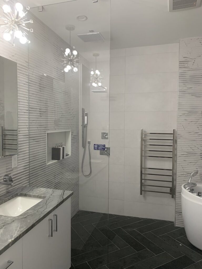 A modern bathroom renovation featuring a walk-in shower with glass enclosure and new vanity, completed by Boyd's Custom Building in Charlotte, NC.
