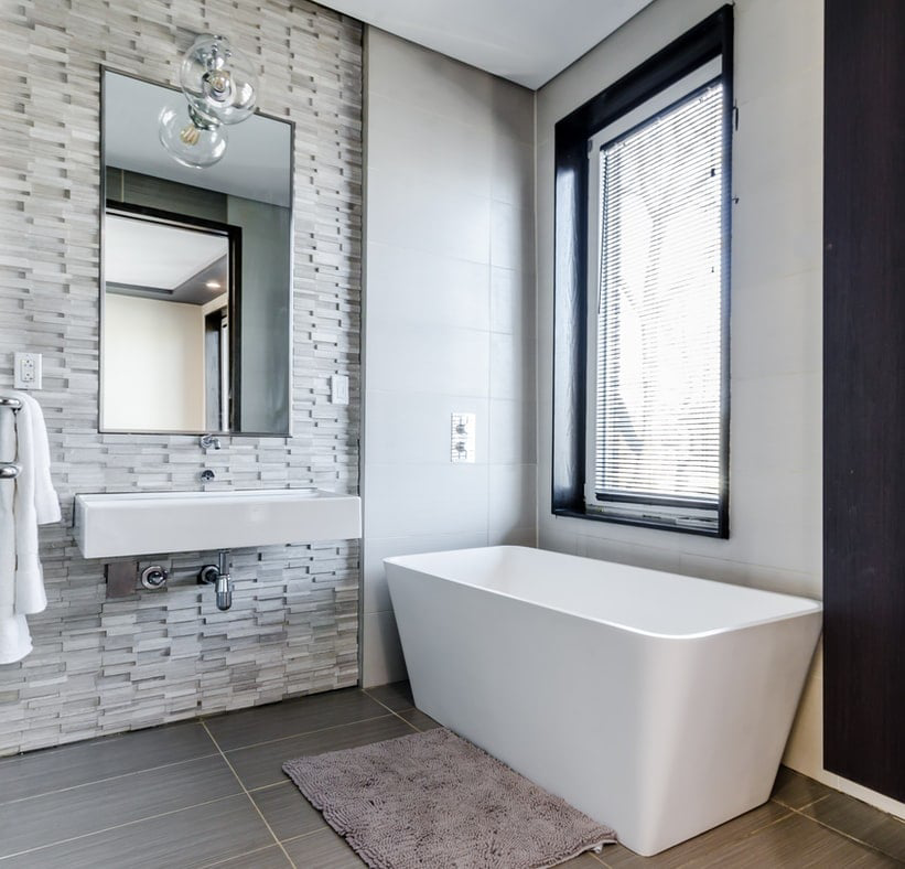 A modern bathroom renovation featuring a freestanding tub and tile work by Pride Tile Inc. in Worcester, MA.