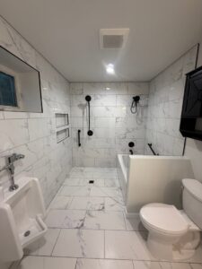 A modern bathroom renovation with marble-look tiles and a spacious walk-in shower by 3Rivers General Contracting in Pittsburgh, PA.